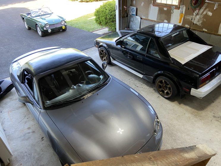 2004 Mazdaspeed Miata parked in garage next to MR2 and TR4A projects