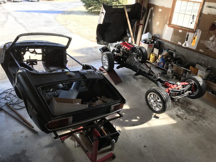 Side by side picture of 1972 Triumph Spitfire bodyshell and restored chassis with the Miata drivetrain in it